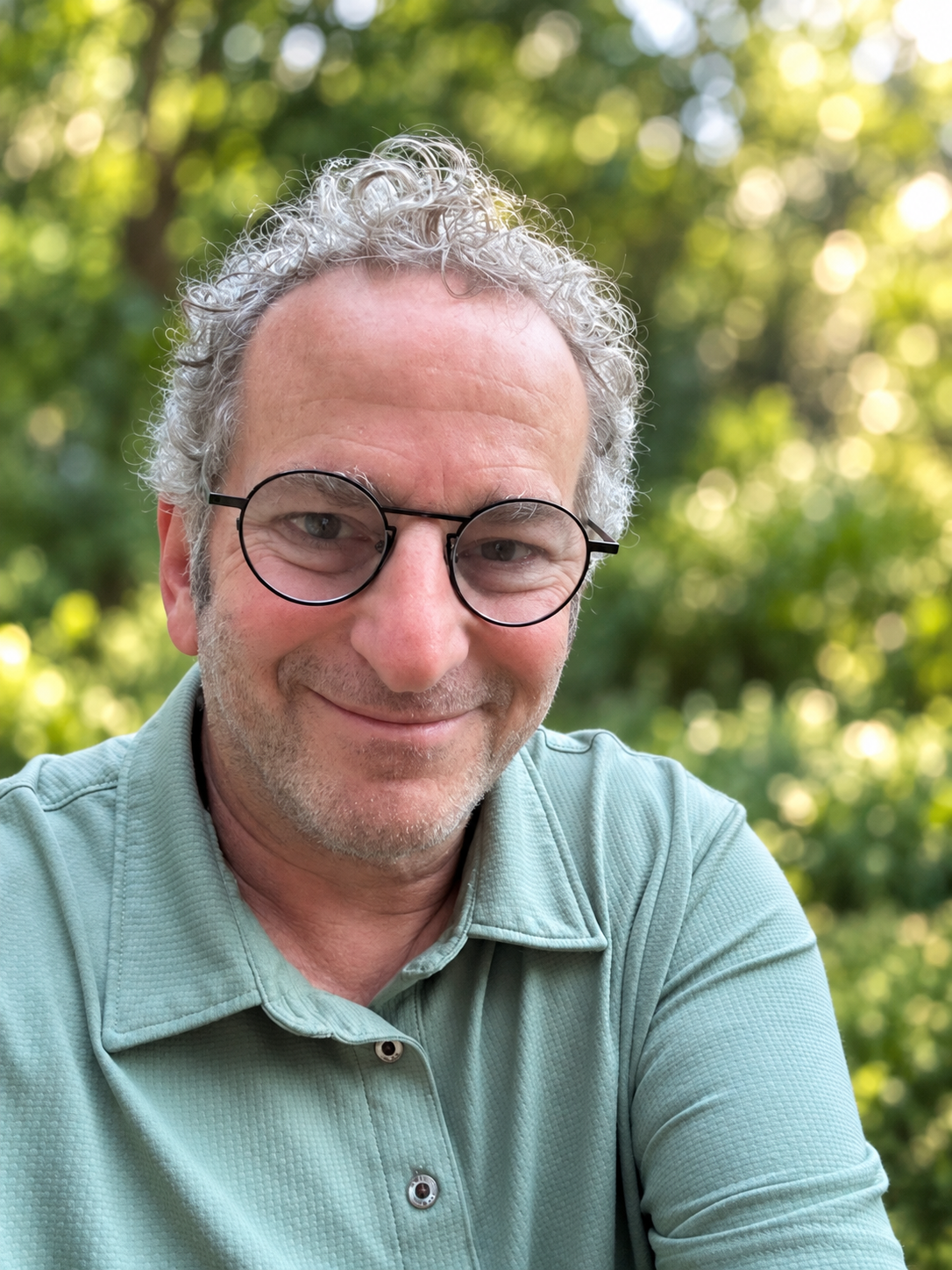 Jeff Rabkin of JustFix Wood, smiling in a green polo shirt outdoors