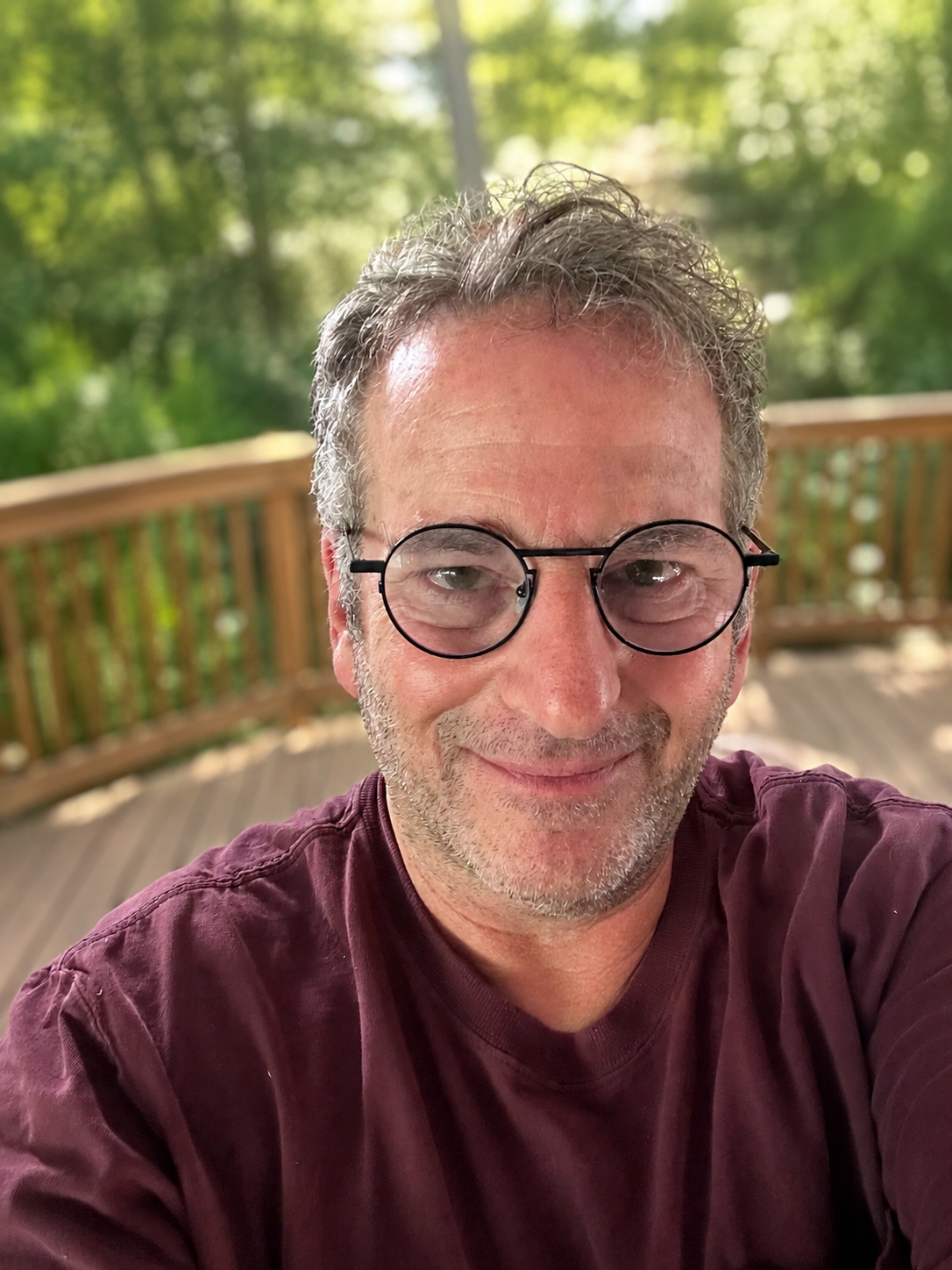 JustFix Wood owner on a deck, the person who answers the phone and does the work